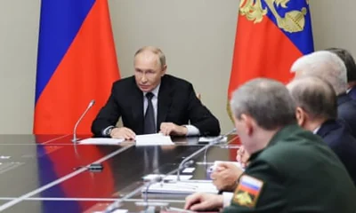 Russian President Vladimir Putin (L) chairs a meeting with members of Russia’s security council.