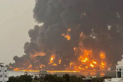 A handout picture obtained from Yemen's Huthi Ansarullah Media Center show a huge column of fire erupting following reported strikes in the port city of Hodeida on July 20, 2024