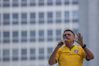 Jair Bolsonaro, the former president of Brazil, speaking into a microphone.