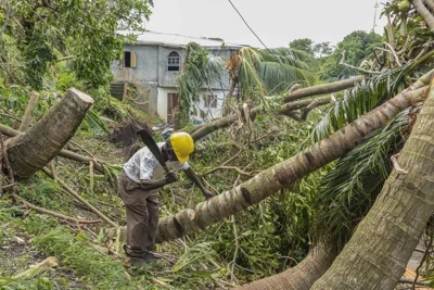 Pastor Winston Alleyne clears trees felled by Hurricane Beryl in Ottley Hall, St. Vincent and the Grenadines, Tuesday, July 2, 2024. AP PHOTO