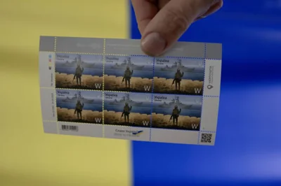 A photo shows a set of postage stamps commemorating the Snake Island incident