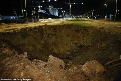 A view of a giant hole as Israeli forces arrive in the area and investigate debris of missiles fired from Iran towards Israel, after they fall in Herzliya, north of Tel Aviv, Israel on October 01, 2024