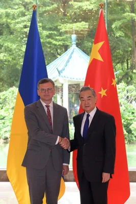 Ukraine's Foreign Ministry Dmytro Kuleba, left, shakes hands with China's Foreign Minister Wang Yi before a meeting in Guangzhou, in this photo released by Xinhua News Agency, July 24. AP-Yonhap 