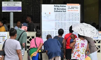 Voters check the list of electors at a polling station in Honiara on Wednesday