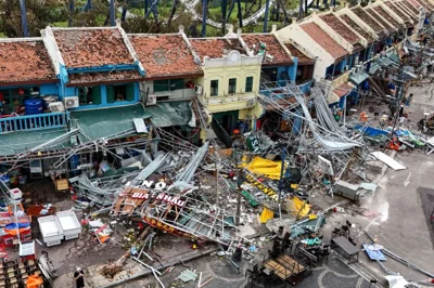 Debris around a row of shophouses in Vietnam after Typhoon Yagi. Roof tiles have been ripped off and awnings torn apart.