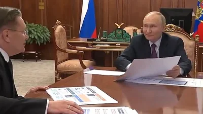 Putin is seen flashing a smug smile at Likhachev - but he was quickly taken down a peg by the official who pointed out his error