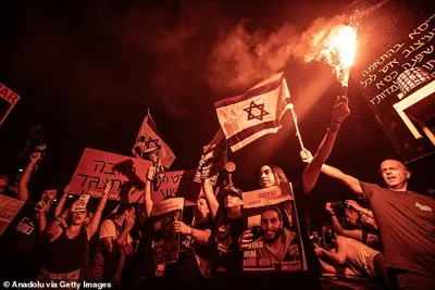 Thousands holding banners and gather in Tel Aviv during a demonstration to demand a hostage swap deal and the dismissal of the government led by Netanyahu on June 29