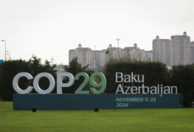 A sign of the COP29 United Nations Climate Change Conference is seen against the cityscape in Baku, Azerbaijan, late last month. The conference will start next week