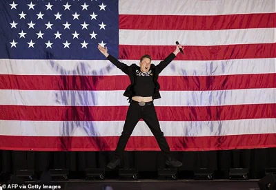 Tesla and SpaceX CEO Elon Musk jumps on stage as he arrives to speak at a town hall event hosted by America PAC in support of former US President and Republican presidential candidate Donald Trump at the Greater Philadelphia Expo Center in Oaks, Pennsylvania, on October 18, 2024