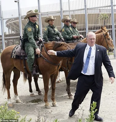 Tom Homan, then-Acting Director of Immigration and Customs Enforcement shakes hands with Border Patrol agents after a press conference at Border Field State Park on May 7, 2018 in San Ysidro, California