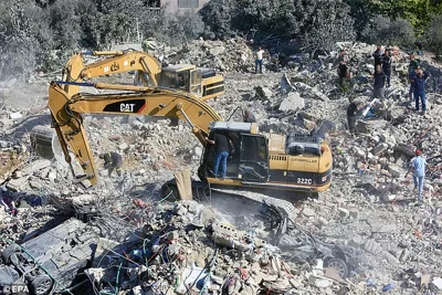 Rescuers search the rubble of a destroyed building targeted by an Israeli airstrike in Sarafand, southern Lebanon, 30 October 2024