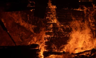 A house burns during a wildfire