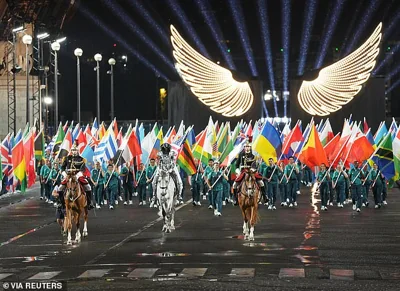 A horsewoman delivers the Olympic flag at the end of the opening ceremony, surrounded by flagbearers for all the competing nations