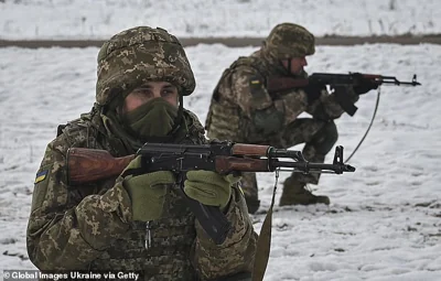 Ukrainian servicemen overcome an obstacle course during military training on November 24