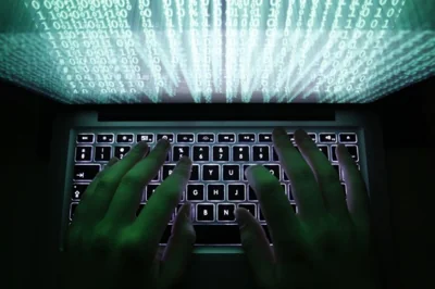 Illustration file picture shows a man typing on a computer keyboard in Warsaw