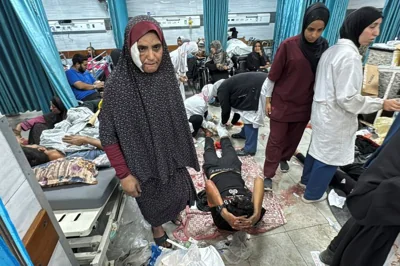 Injured Palestinians lie on beds and the floor at Kamal Adwan Hospital after Israeli forces withdrew from there, in Jabalia in northern Gaza Strip