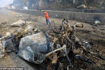 The wreckage of a vehicle lies on the Araya-Kahhale road on October 30, 2024, at the site of an Israeli strike