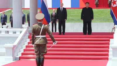 In this pool photograph distributed by the Russian state agency Sputnik, North Korea's leader Kim Jong Un (R) and Russian President Vladimir Putin attend a welcoming ceremony at Kim Il Sung Square in Pyongyang on June 19, 2024. Russian President Vladimir Putin landed in North Korea early on June 19, the Kremlin said, kicking off a visit set to boost defence ties between the two nuclear-armed countries as Moscow pursues its war in Ukraine. (Photo by Gavriil GRIGOROV / POOL / AFP) / -- EDITOR'S NOTE : THIS IMAGE IS DISTRIBUTED BY THE RUSSIAN STATE OWNED AGENCY SPUTNIK --