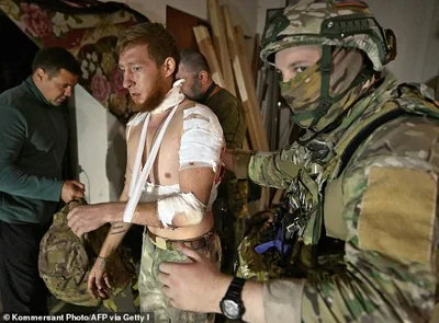 Medics help a local resident in a field hospital at an undisclosed location in the Kursk region on August 11, 202