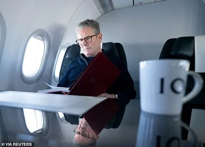 Sir Keir Starmer works on board a Government plane as he travels to Rio de Janeiro, Brazil, to attend the G20 summit