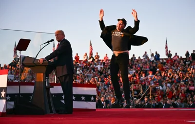 Elon Musk jumps on stage as he joins Donald Trump during a campaign rally at Butler, Pennsylvania