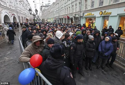 Moldovans living in Russia stand in line at a polling station in the Moldova embassy building