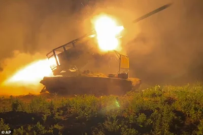 In this photo taken from a video released by Russian Defense Ministry press service on Wednesday, Nov. 13, 2024, the Russian army's multiple rocket launcher Solntsepyok fires towards Ukrainian positions in the border area of Kursk region, Russia