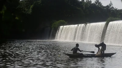 Fishermen paddle their canoe near a dam that sources the sacred river in Esa-Odo Nigeria, on Saturday, 28 May 2022. 