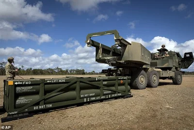 Above, US Army Sergeant and gunner Ian Ketterling prepares the crane for loading an ATACMS on to a High Mobility Artillery Rocket System (HIMARS) in Queensland, Australia, on July 26, 2023