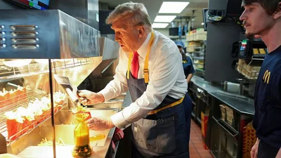 Former President Donald Trump serves french fries during a McDonald's visit on 20 October in Pennsylvania. 