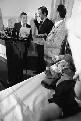 A somber Biden is sworn in as a US Senator on January 5, 1973 from a Wilmington, Delaware hospital with his four-year-old son Beau lying on his bed after surviving the crash that killed his mother and sister. Hunter Biden also survived the crash and was recovering at this same hospital. This horrific event was kickstarted Biden's reputation as a man who could weather tragedy