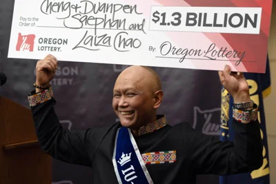 Powerball winner Cheng “Charlie” Saephan celebrates his win at a news conference in Oregon