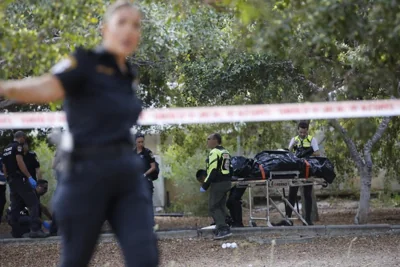 Israeli police remove a body from the scene of a deadly stabbing attack in Holon, Israel on August 4, 2024. 