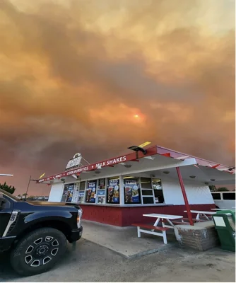 Fire and smoke flare behind 
B&J Drive - In in Ventura, Calif. on Nov. 6, 2024.