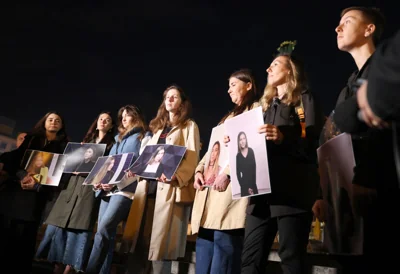 Colleagues of Ukrainian journalist Victoria Roshchyna hold photographs of her during an event in honor of her memory at a makeshift memorial for fallen Ukrainian soldiers at Independence Square in Kyiv