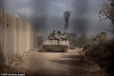 An Israeli battle tank (pictured) entering Lebanon from northern Israel at the southern Lebanese border point of Naqoura. UN peacekeepers in Lebanon said Israeli tanks broke through a gate to enter a Blue Helmet position