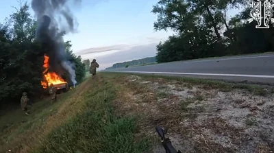 The bodycam footage captures the moment the soldiers use what appears to be a mini-rocket launcher to destroy a Russian truck hidden behind some trees