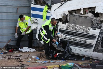 Israeli emergency responders clean the site after a driver rammed his truck into a crowd of people at a bus stop in Ramat Hasharon, north of Tel Aviv on October 27, 2024