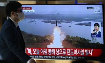 A man walks past a television screen showing a news broadcast with file footage of a North Korean missile test, at a train station in Seoul last week