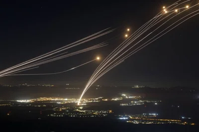 Rockets fired from southern Lebanon are intercepted by Israel's Iron Dome air defence system over the Upper Galilee region in northern Israel, on August 4, 2024, amid ongoing cross-border clashes between Israeli troops and Lebanon's Hezbollah fighters. AFP PHOTO