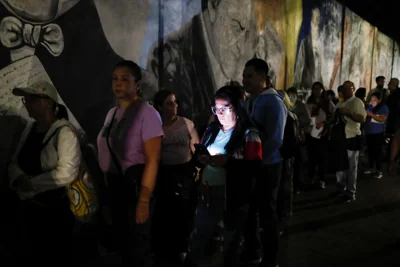 Voters line up at a voting station prior to the opening of the polls for presidential elections in Caracas, Venezuela