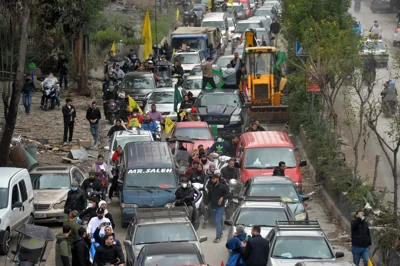 Civilians celebrate on a street after the ceasefire with Israel came into effect