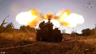 n this photo taken from video released by the Russian Defence Ministry on Aug. 18, 2024, Russian soldiers fire a Giatsint-S gun toward Ukrainian positions at an undisclosed location near the Russian-Ukrainian border area in the Kursk region