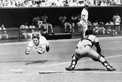 Pete Rose midair sliding headfirst without a helmet. 