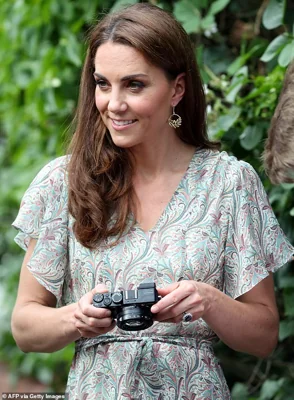 The Princess of Wales pictured holding a camera as she takes part in a a photography workshop with the charity 'Action for Children' in Kingston in June 2019