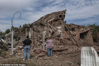 Civilians look at a heavily damage and partially collapsed house after a Russian shelling in the town of Kostiantynivka, Ukraine on September 05, 2024