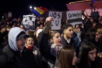 Youngsters shout slogans during a protest against Calin Georgescu, the far-right candidate for presidency who won the first round of elections in Bucharest, 25 November 2024