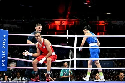 The Italian fighter (in the blue) refused the handshake and fell to the canvas and appeared to wipe away a tear. Winner Khelif is pictured in the red as her opponent leaves the ring