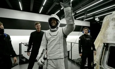 Jared Isaacman in a spacesuit waving.