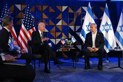 Joe Biden and Benjamin Netanyahu seated with flags behind them.